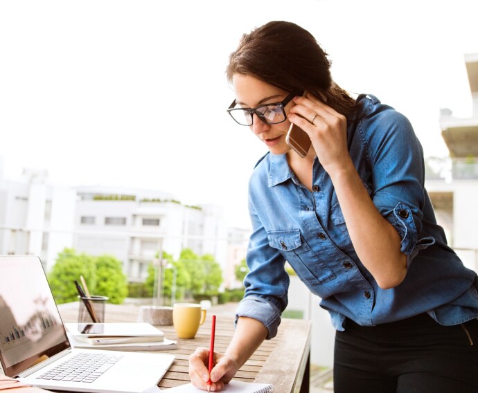 Woman on the phone working.